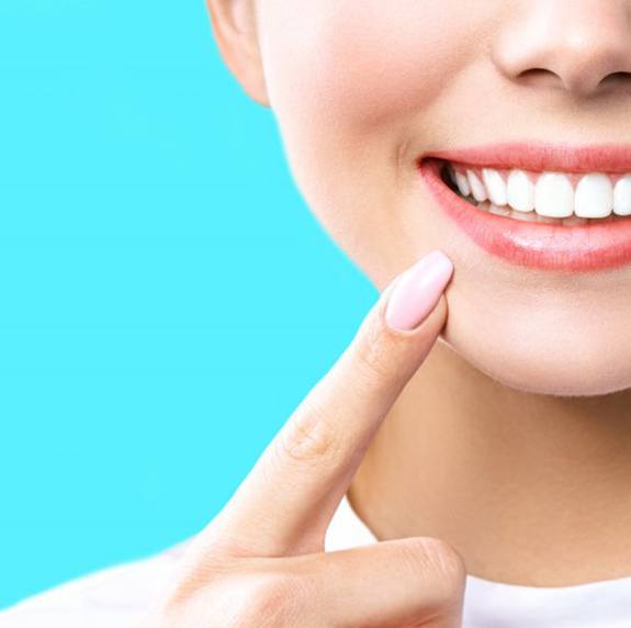 Woman smiling and outlining her smile with her hands
