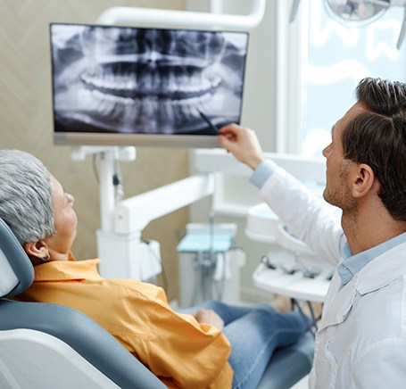 Dentist reviewing a dental implant treatment plan with a patient