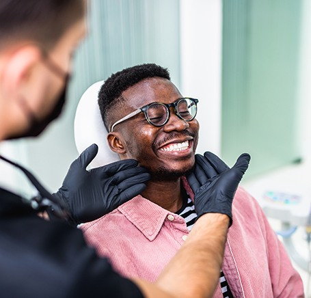 Patient in Durham smiling after receiving final dental implant restoration