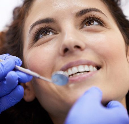 a patient smiling while visiting her dentist