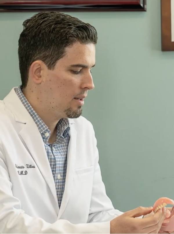 Durham North Carolina dentist holding a denture