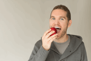 a man biting into an apple